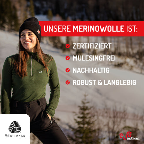 Frau in einer Schneelandschaft trägt grünes Merino-Oberteil aus zertifizierter Wolle